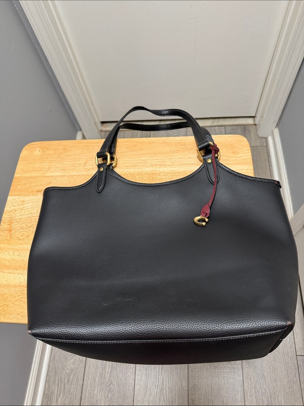 Coach Black Leather Tote with Burgundy Charm